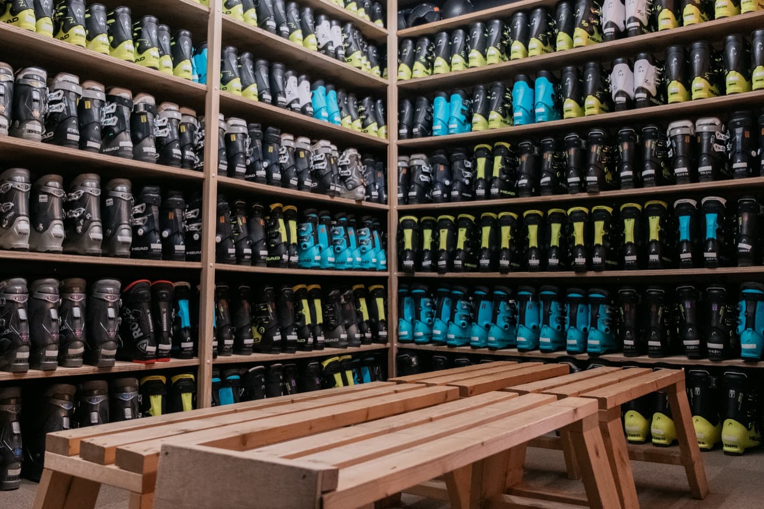 Boot wall with sized ski boots stacked floor to ceiling