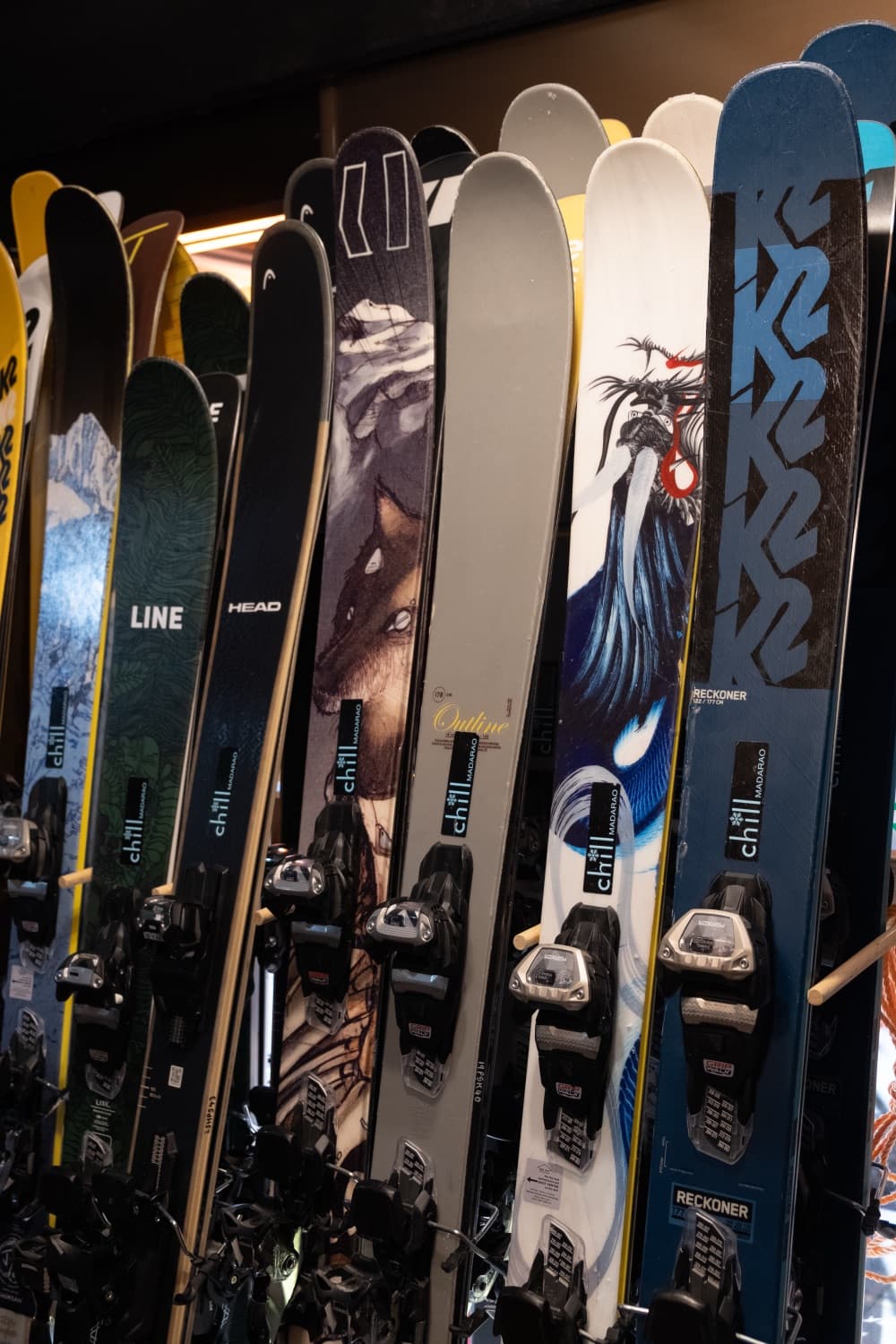 Skis from K2, Head, Völkl and Line stacked on the rack